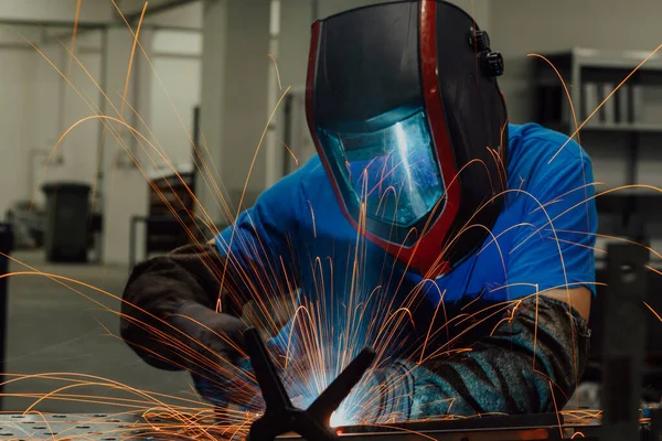 Professional Heavy Industry Welder Working Inside factory, Wears Helmet and Starts Welding. Selective Focus — Stok fotoğraf