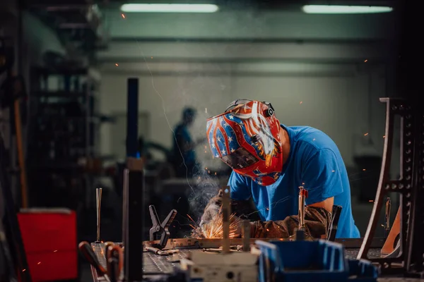 Professional Heavy Industry Welder Working Inside factory, Wears Helmet and Starts Welding. Selective Focus — Stock Photo, Image