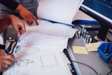 Engineer technician designing drawings mechanical parts engineering Enginemanufacturing factory Industry Industrial work project blueprints measuring bearings caliper tools