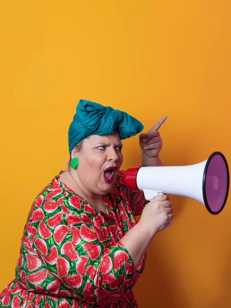 Funny plus size woman posing isolated on yellow background studio portrait. Overweight lady screaming in a megaphone. People emotions lifestyle concept. Mock up copy space. — Foto Stock