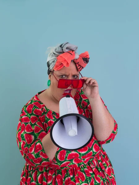 Funny plus size woman posing isolated on cyan background studio portrait. Screaming in a megaphone. People emotions lifestyle concept. Mock up copy space. —  Fotos de Stock