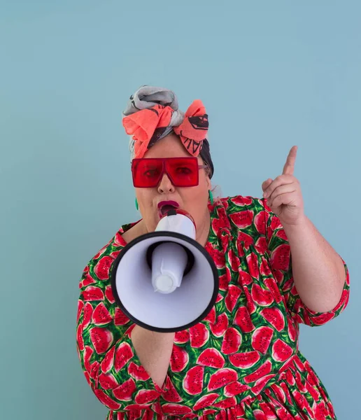 Funny plus size woman posing isolated on cyan background studio portrait. Screaming in a megaphone. People emotions lifestyle concept. Mock up copy space. — Fotografia de Stock