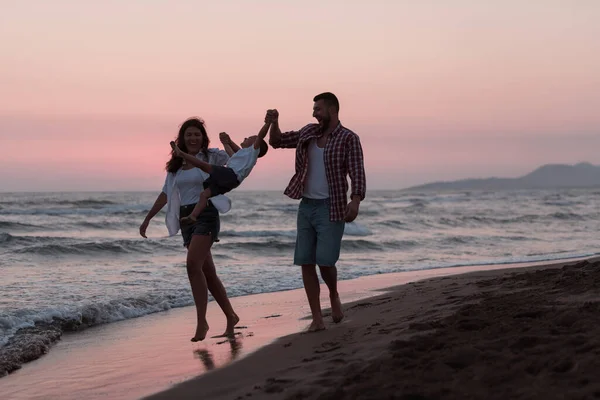 Happy young family have fun and live healthy lifestyle on beach. Selective focus — 图库照片