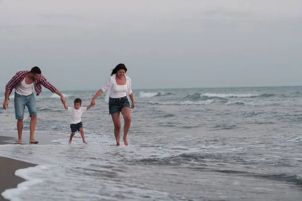 Happy young family have fun and live healthy lifestyle on beach. Selective focus — Fotografia de Stock