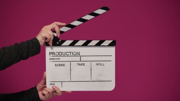 Human hands hold and clap with clapperboard. Beginning of scene in film or television production. — Stock Video