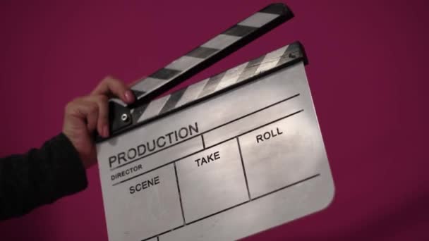 Human hands hold and clap with clapperboard. Beginning of scene in film or television production. — Stock Video