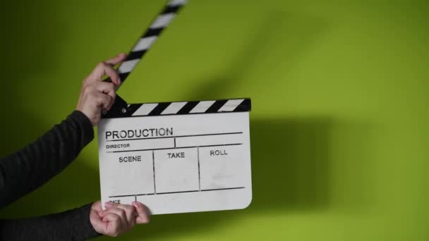 Human hands hold and clap with clapperboard. Beginning of scene in film or television production. — Stock Video