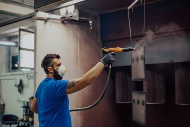 Ressam demir elementi boyar. Endüstriyel boya parçaları. Metal tasarımlar. Yüksek kaliteli fotoğraf.