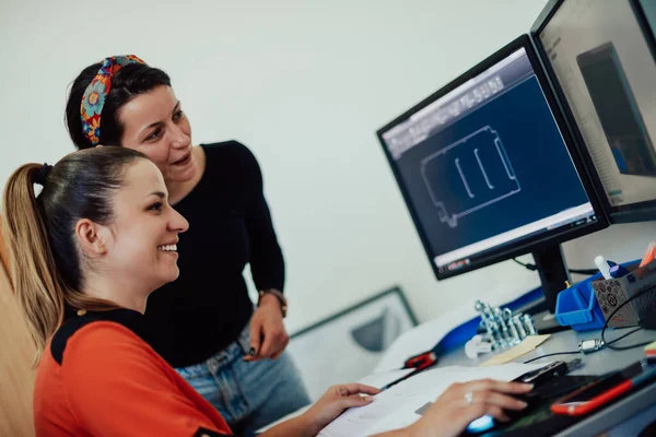 Within the heavy industry, a factory industrial engineer measures with a caliper and on a personal computer Designs a 3D model. High quality photo