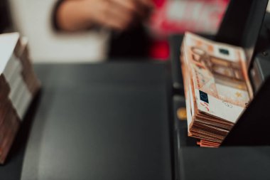 Sorted banknotes are placed on the table after it is counted on the electronic money counting machine. High quality photo