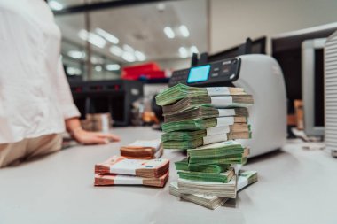Sorted banknotes are placed on the table after it is counted on the electronic money counting machine. High quality photo