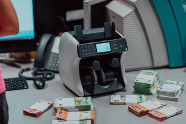 Sorted banknotes are placed on the table after it is counted on the electronic money counting machine. High quality photo