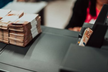 Sorted banknotes are placed on the table after it is counted on the electronic money counting machine. High quality photo