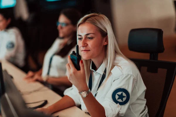 Female Security Operator Holding Portable Radio Hand While Working Data — Foto Stock