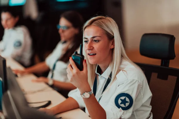 Female Security Operator Holding Portable Radio Hand While Working Data — Foto Stock