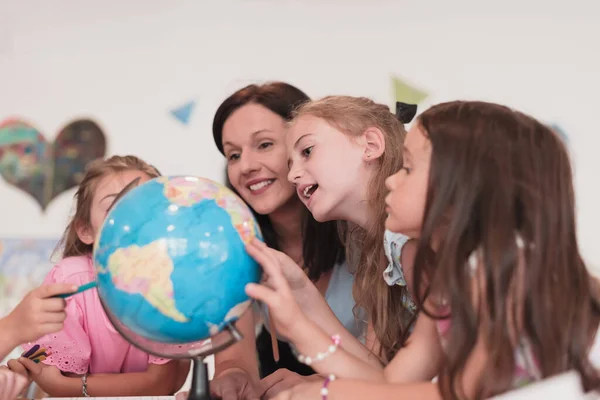 Female Teacher Kids Geography Class Looking Globe Side View Group — 스톡 사진