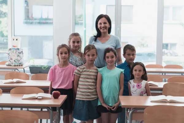 Portrait of children in a preschool institution with their teacher in a torn classroom. Selective focus . High quality photo