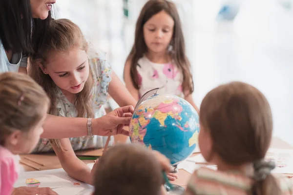 Female Teacher Kids Geography Class Looking Globe Side View Group — 스톡 사진