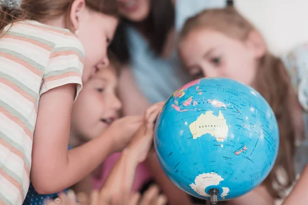 Female Teacher Kids Geography Class Looking Globe Side View Group — Stock fotografie