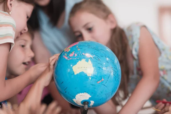 Female Teacher Kids Geography Class Looking Globe Side View Group — Stock fotografie