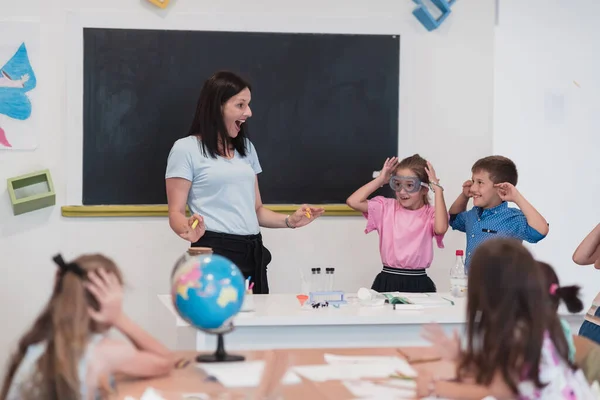 Female Teacher Kids Geography Class Looking Globe Side View Group — Stok fotoğraf