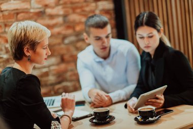 Happy businesspeople smiling cheerfully during a meeting in a creative office. Group of successful business professionals working as a team in a multicultural workplace. High quality photo