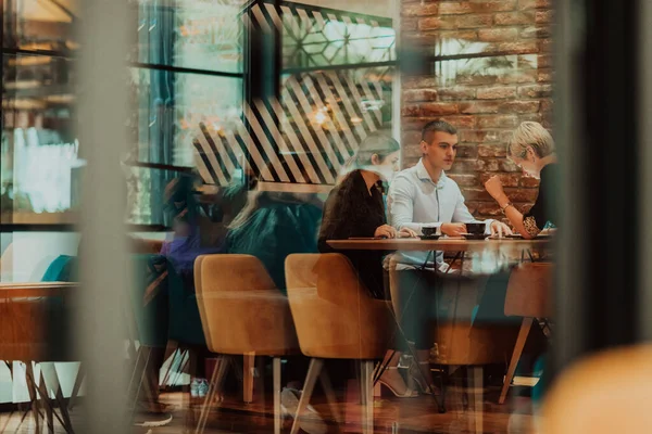 Happy businesspeople smiling cheerfully during a meeting in a creative office. Group of successful business professionals working as a team in a multicultural workplace. High quality photo