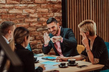 Happy businesspeople smiling cheerfully during a meeting in a creative office. Group of successful business professionals working as a team in a multicultural workplace. High quality photo