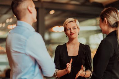 Photo of a business team of young people discussing business ideas in a modern urban environment. Selective focus. High quality photo