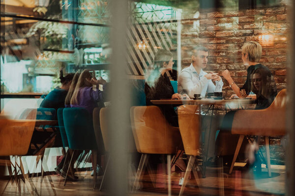 Happy businesspeople smiling cheerfully during a meeting in a creative office. Group of successful business professionals working as a team in a multicultural workplace. High quality photo