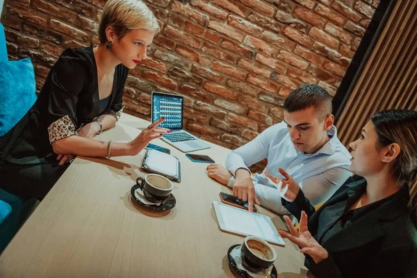 Happy businesspeople smiling cheerfully during a meeting in a creative office. Group of successful business professionals working as a team in a multicultural workplace. High quality photo