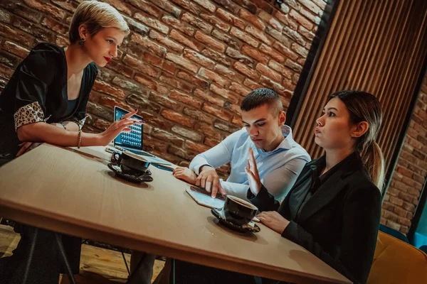 Happy businesspeople smiling cheerfully during a meeting in a creative office. Group of successful business professionals working as a team in a multicultural workplace. High quality photo