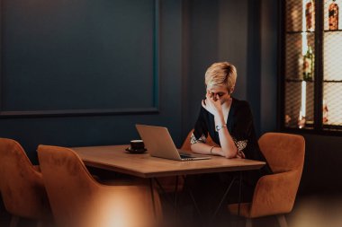 Businesswomen are stressed while working on laptops, Tired businesswomen with headaches in a coffee shop, and feeling sick at work. Selective focus. High quality photo