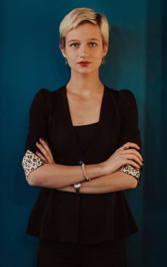 Pretty business woman, successful confidence on modern blue mat background. Selective focus. High quality photo