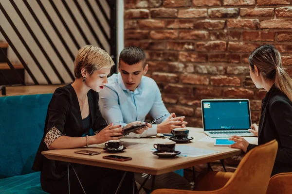 Happy businesspeople smiling cheerfully during a meeting in a creative office. Group of successful business professionals working as a team in a multicultural workplace. High quality photo
