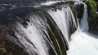Fast extreme dive flight over the epic waterfall at exotic Una river aerial view. FPV sport drone speed movement nature at vegetation greenery wild environment. High quality 4k footage