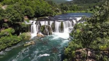 Fast extreme dive flight over the epic waterfall at exotic Una river aerial view. FPV sport drone speed movement nature at vegetation greenery wild environment. High quality 4k footage