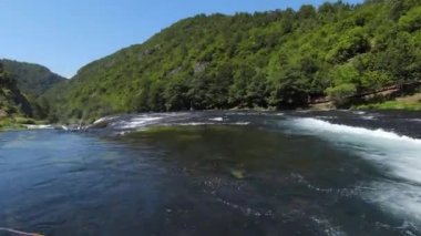 Fast extreme dive flight over the epic waterfall at exotic Una river aerial view. FPV sport drone speed movement nature at vegetation greenery wild environment. High quality 4k footage
