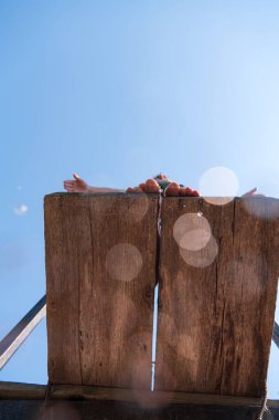 young teen boy ready for a jump in the river on a summer sunny day on vacation superhero shot with selective focus on water drops. High quality photo