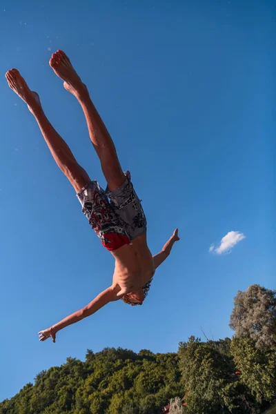 Young Teen Boy Jumping Flying Diving River Clear Blue Sky — Foto de Stock