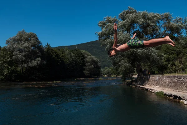 Young Teen Boy Jumping Flying Diving River Clear Blue Sky — Stock fotografie