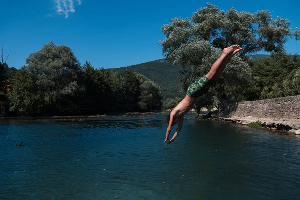 Young Teen Boy Jumping Flying Diving River Clear Blue Sky — Stockfoto