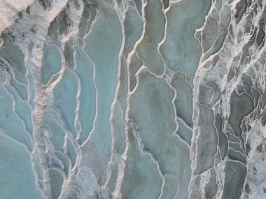 Pamukkale Travertines Cinematic Aerial Drone footage. Turkish famous white thermal bath with healthy clean water in a beautiful sunset. Aegean Region, Denizli Turkey