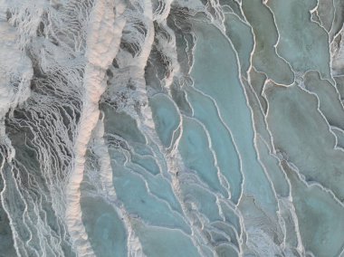 Pamukkale Travertines Cinematic Aerial Drone footage. Turkish famous white thermal bath with healthy clean water in a beautiful sunset. Aegean Region, Denizli Turkey