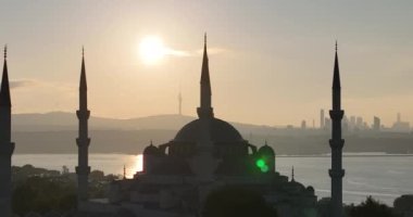 Istanbul, Turkey. Sultanahmet with the Blue Mosque and the Hagia Sophia with a Golden Horn on the background at sunrise. Cinematic Aerial view. Hi quality 4K footage.