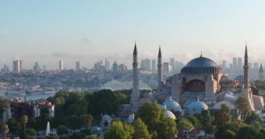 Istanbul, Turkey. Sultanahmet area with the Blue Mosque and the Hagia Sophia with a Golden Horn and Bosphorus bridge in the background at sunrise. Cinematic Aerial view. Hi quality 4K footage.