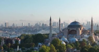 Istanbul, Turkey. Sultanahmet with the Blue Mosque and the Hagia Sophia with a Golden Horn on the background at sunrise. Cinematic Aerial view. Hi quality 4K footage.