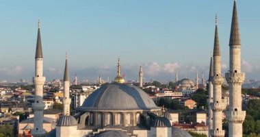 Istanbul, Turkey. Sultanahmet area with the Blue Mosque and the Hagia Sophia with a Golden Horn and Bosphorus bridge in the background at sunrise. Cinematic Aerial view. Hi quality 4K footage.