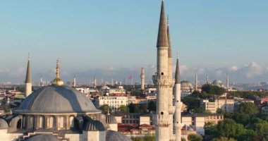 Istanbul, Turkey. Sultanahmet with the Blue Mosque and the Hagia Sophia with a Golden Horn on the background at sunrise. Cinematic Aerial view. Hi quality 4K footage.