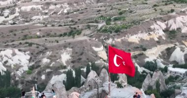 Aerial view of natural rock formations in the sunset, valley with cave houses in Cappadocia, Turkey. Natural landscape city lights at the night. Cinematic epic drone 4k hi quality footage.